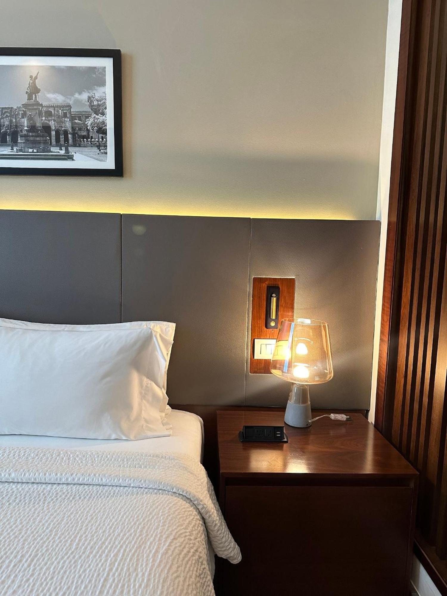 Holiday Inn Santo Domingo By Ihg Экстерьер фото A bedside table with a lamp